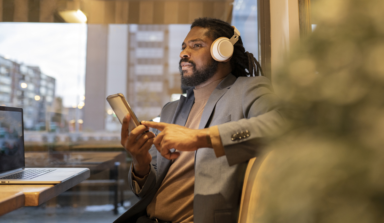 Black Business man drinking coffee and listening to music his in office.